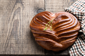 Heart shaped bun on wooden table