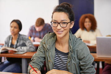 A solid education for a promising future. Portrait shot of a happy female student sitting at her...
