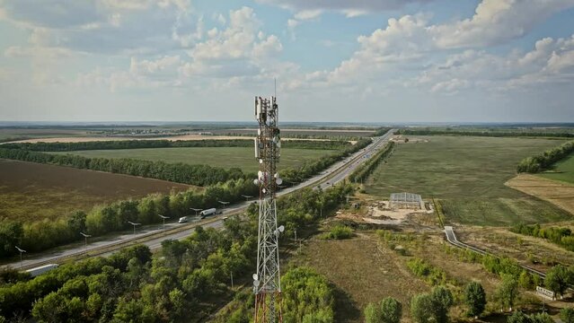 Cell site of telephone tower with 5G base station transceiver. Aerial view of telecommunication antenna mast
