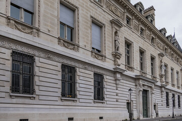 Fototapeta na wymiar Architectural details of old buildings in Paris: The Criminal Court of Paris (Tribunal Correctionnel) at 14 Quai Goldsmiths. Paris. France.