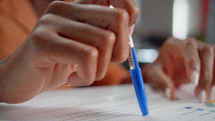 An african professor is checking her students' homework close up