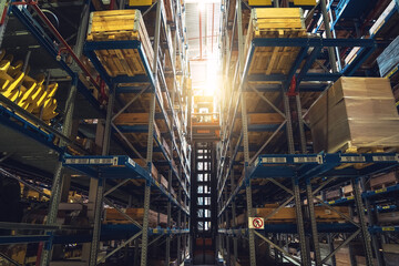 Obraz premium Modern distribution warehouse interior with many goods in boxes on shelves.