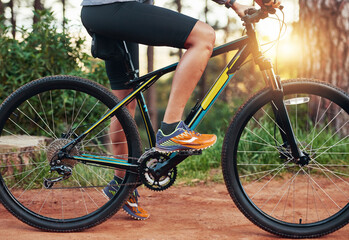 Fototapeta premium Dominating the trails. Shot of a female mountain biker out for an early morning ride.