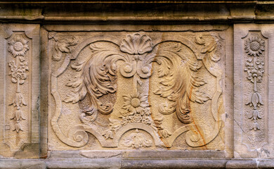 Stone wall with carved floral pattern	