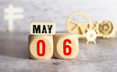 May 6, Cover design with number cube on a white background and granite table.