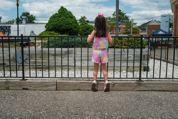 Young girl looking over a railing