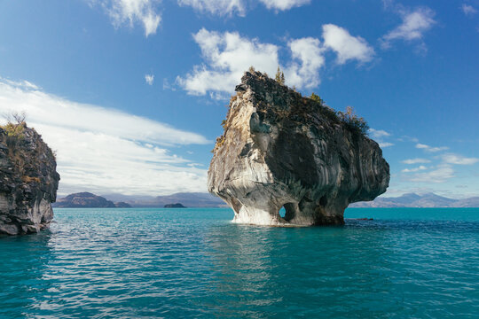 Marble Chapel surrounded by turquoise pristine lake water.