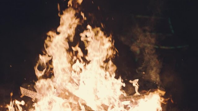A UTV races past a blazing fire at 120 frames per second at night