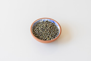 Okra seeds in a clay bowl