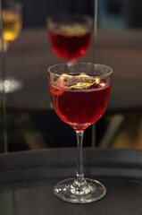 Transparent cocktails in glasses. Red and yellow cocktail at the bar