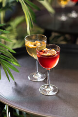 Transparent cocktails in glasses. Red and yellow cocktail at the bar
