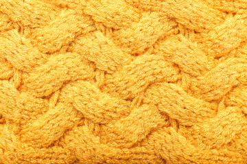 Texture of yellow knitted clothes, closeup