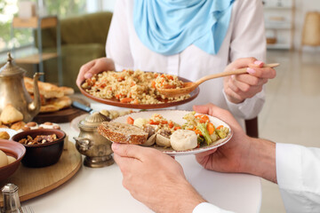 Obraz na płótnie Canvas Muslim couple having breakfast together. Celebration of Eid al-Fitr