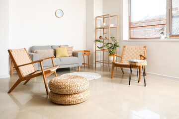 Interior of modern living room with sofa and wooden armchairs