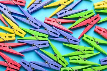 Plastic clothes pins on color background