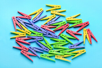 Plastic clothes pins on color background