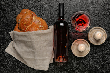 Traditional challah bread with wine and candles on dark background. Shabbat Shalom - obrazy, fototapety, plakaty