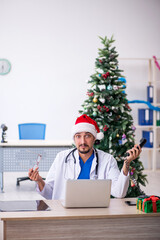 Young male doctor celebrating Christmas at the hospital