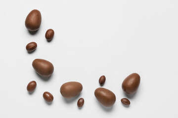 Delicious chocolate eggs on light background