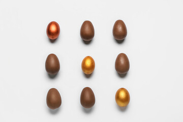 Delicious chocolate eggs on light background