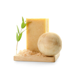 Composition with soap bar, sea salt and wooden massage ball on white background
