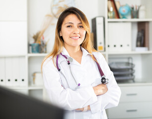 Portrait of latino female doctor posing in office and friendly smiling