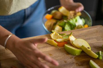 Woman throwing away organic waste