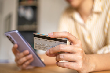 Young woman Paying Bills with mobile phone