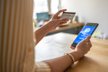 Young woman Paying Bills with mobile phone