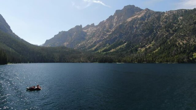 Wide Aerial shot over Sawtooths Idaho Redfish lake above boat