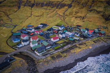Beautiful aerial view of the Tjornuvik village in the middle of the Mountains in Faroe Island. November 2021