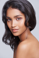 Naklejka premium All natural beauty. Shot of a beautiful young posing over a gray background.