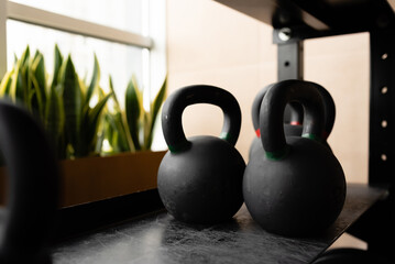 Naklejka na ściany i meble Sports accessories and dumbbells on a black background. Fitness, bodybuilding, sport and healthy lifestyle concept