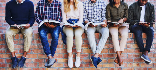 Studying on campus. Cropped shot of a group of unrecognizable university students studying while...