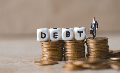 Block word debt on pile of coins with business man, Payment of taxes and of debt to the state,...