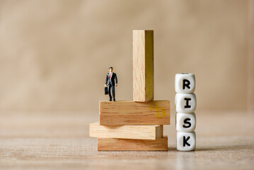 Risk business concept, business man stands on wooden blocks. risk control and managment idea