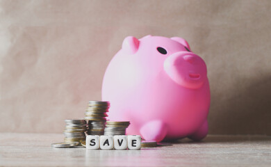 Save money concept, stack coins and save block word Save money for investment or education study with piggy bank background