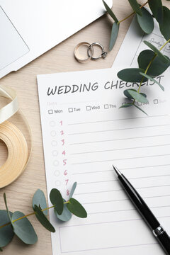 Flat lay composition with Wedding Checklist on white wooden table