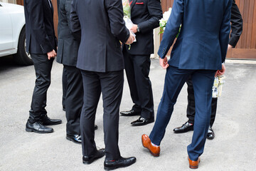 Group of young men in suits standing waiting for their prom dates - obrazy, fototapety, plakaty