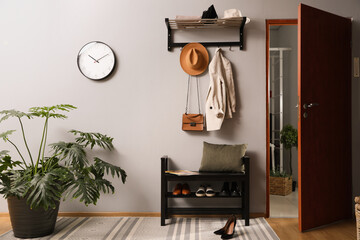Hallway interior with stylish furniture, clothes and accessories