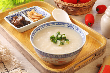 Rice porridge with spring onion on the table 