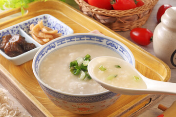 Rice porridge with spring onion on the table 