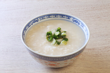 Rice porridge with spring onion on the table 