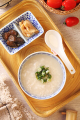 Rice porridge with spring onion on the table 
