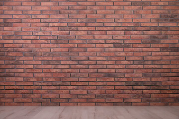 Empty room with brick wall and wooden floor