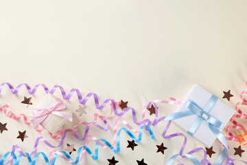 Colorful serpentine streamers, gift boxes and confetti on white background, flat lay. Space for text