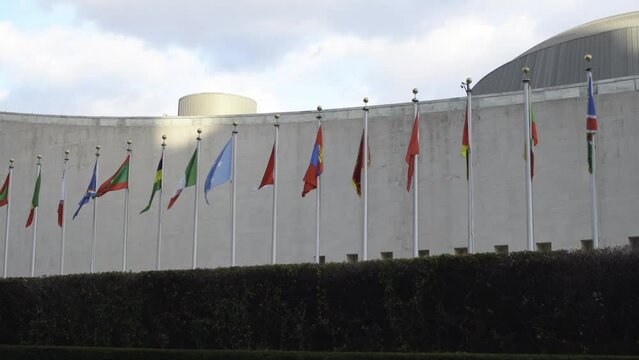 Flags on Flag pole in front of United Nations in New York City. Slow Motion flags moving slightly in the wind