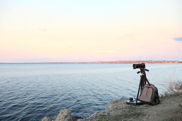 Professional photography equipment on rocky river coast