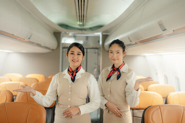 Portrait of Cabin crew or air hostess in uniform standing and smile. Airline transportation and...