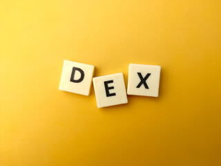 Top view toys word with text DEX on yellow background.